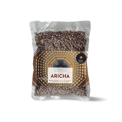 Ethiopian Aricha natural coffee beans in a bag with a label showing the Aricha region and rich, aromatic coffee.