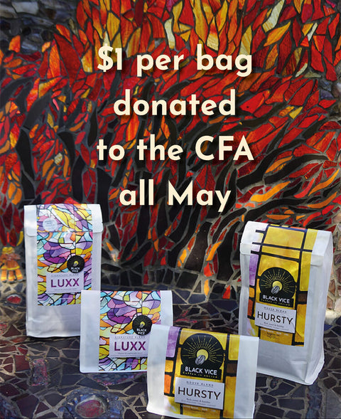 Colorful coffee bags with text about donation to CFA in front of a mosaic wall. $1 donation per bag to the CFA all May. 